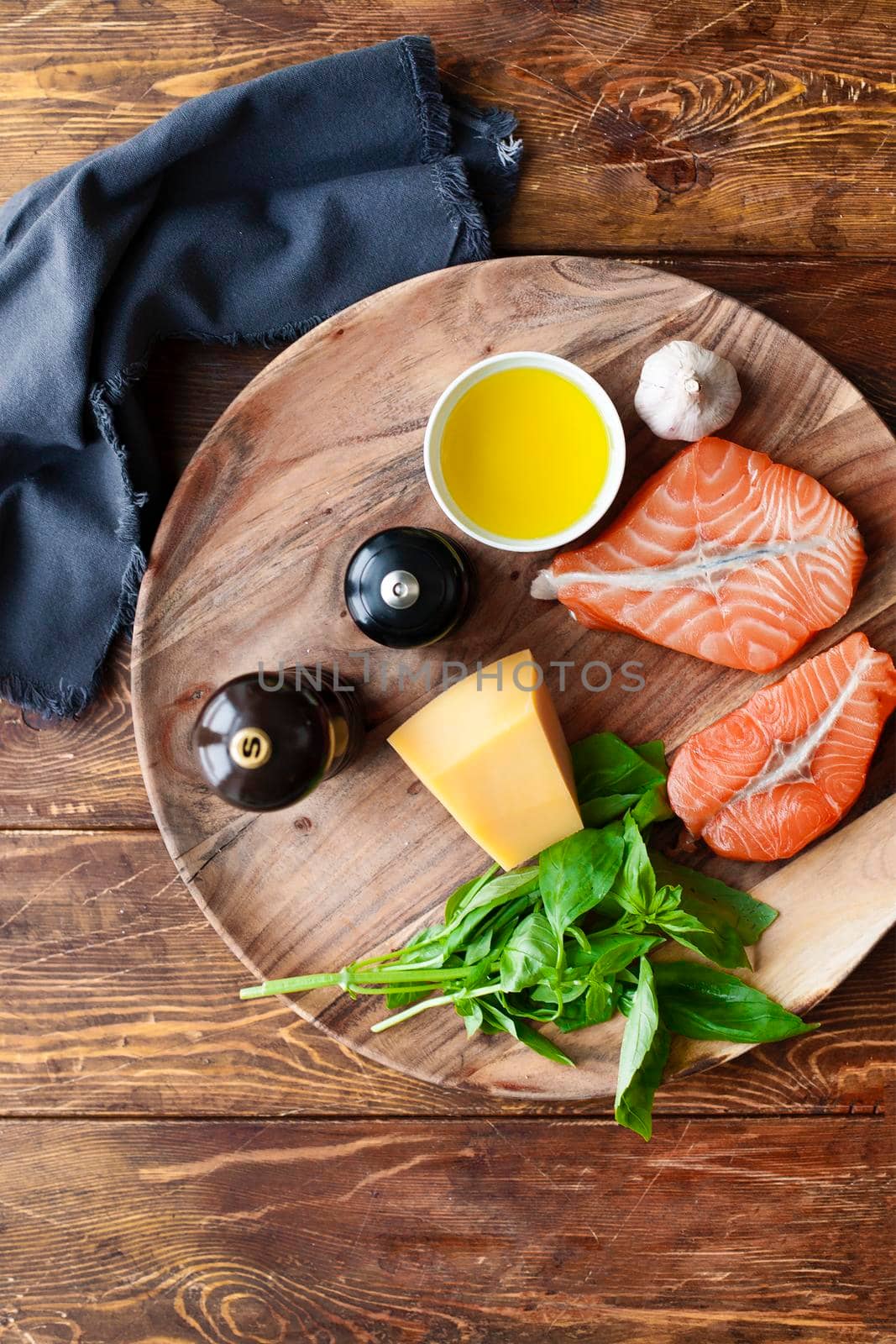 Raw humpback salmon steaks, rustic wooden background, above view. Fillet with fresh ingredients for tasty cooking and frying pan. Top view. Healthy and diet food concept.