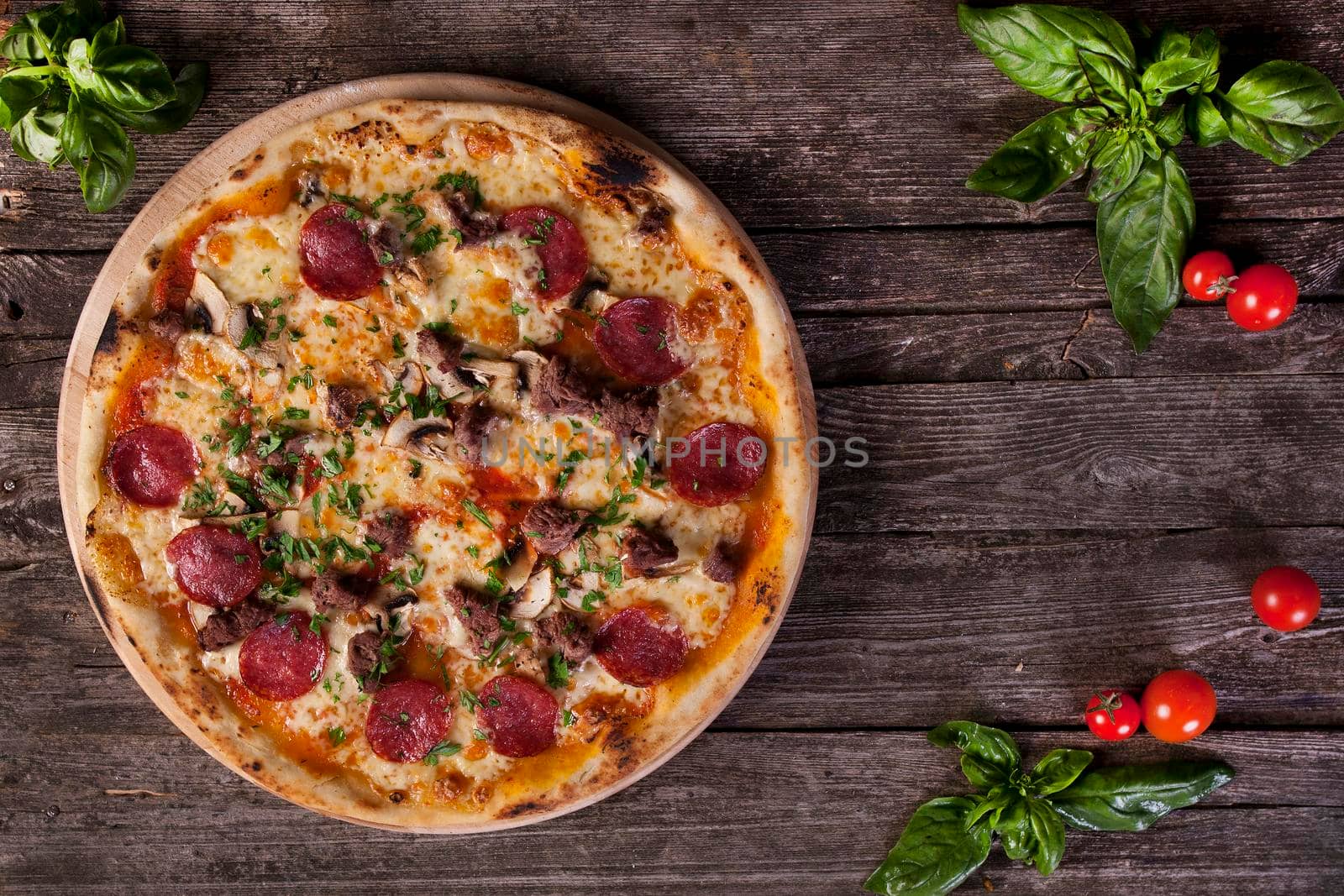 Pepperoni Pizza with salami, mushrooms , meat , beef, cheese and green onions on the wooden background. Top view.