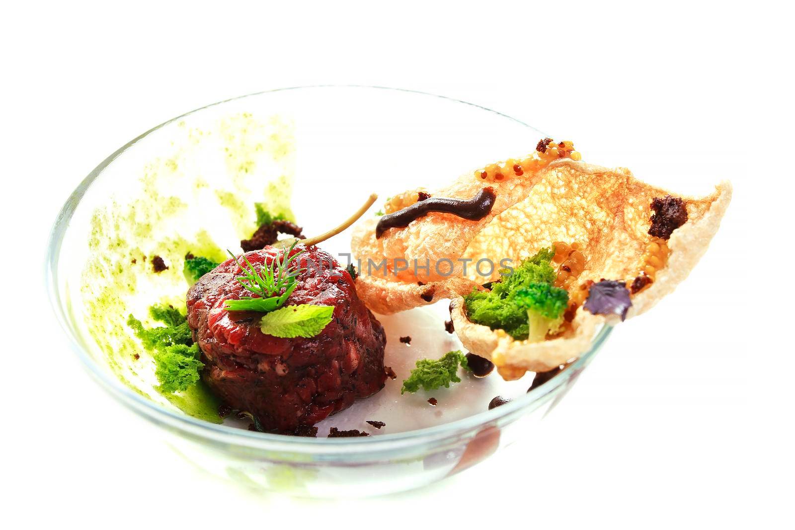 Molecular modern cuisine. Chips Pigskin with tartare or carpaccio of beef. Stock image. Isolated on white.