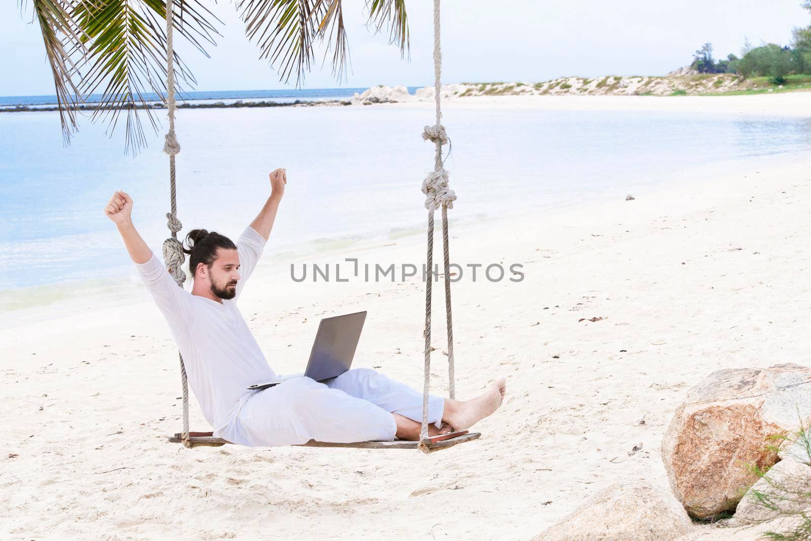 Businessman freelance on beach with laptop. Sand beach by Jyliana