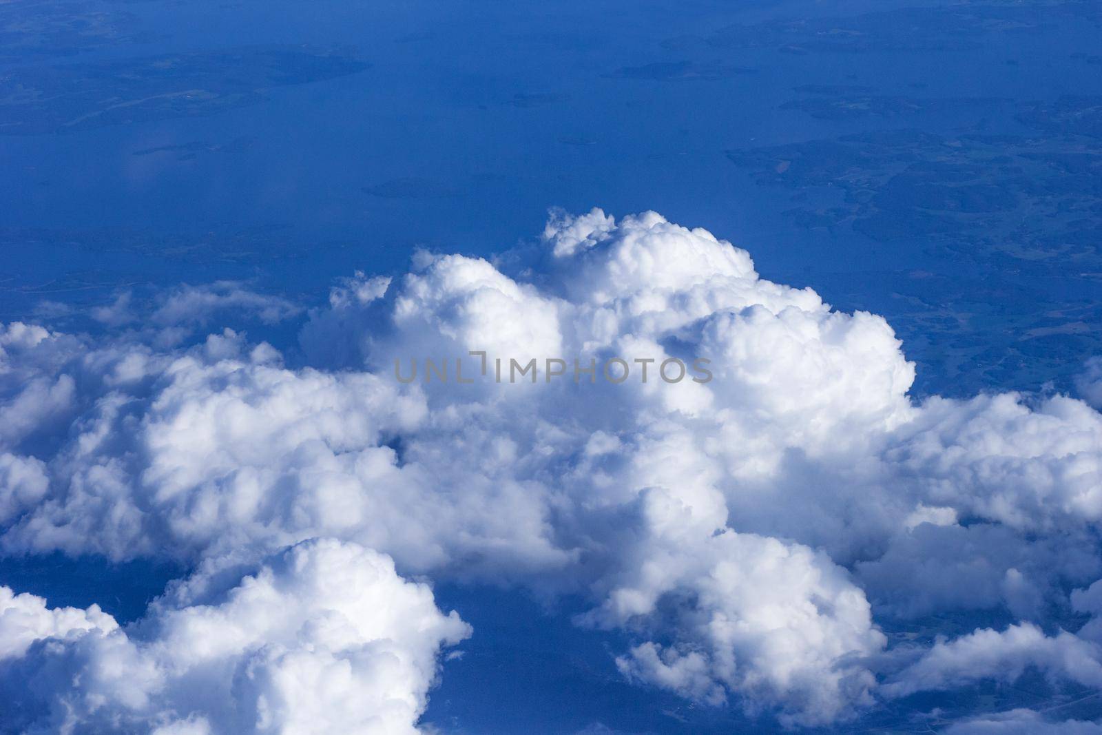 White clouds on blue sky. View from plane