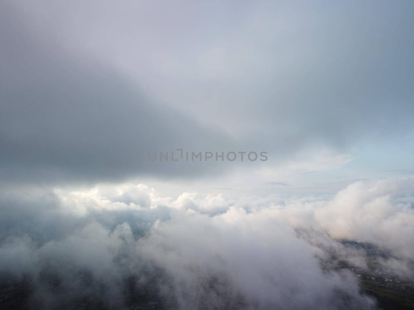 Aerial view. Blue sky sun and fog over calm sea. The drone flies over foggy and fluffy clouds. Abstract aerial nature summer ocean sunset sea and sky background. Vacation, travel and holiday concept. by panophotograph