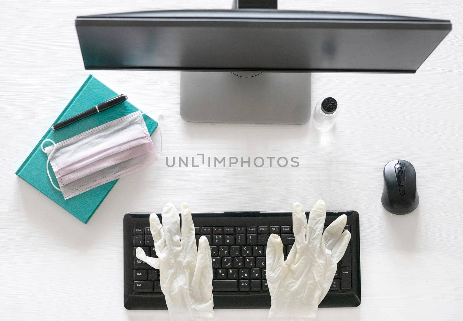 Flat lay, Top view work form home and COVID-19 prevention concept on wooden office table desk, Laptop computer with clean gel and mask, Medical gloves and supplies with copy space