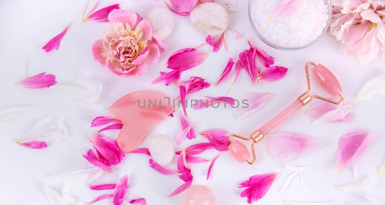 Pink flowers on white background spa facial. Selective focus. by yanadjana