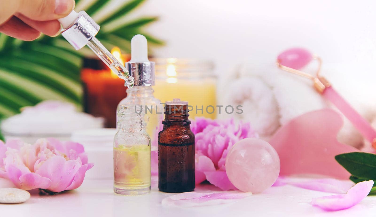 Pink flowers on white background spa facial. Selective focus. by yanadjana