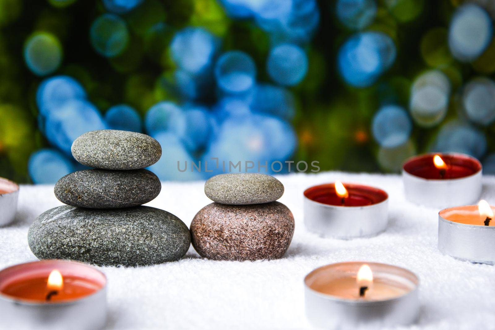 Zen concept, spa pebbles stones and burning aroma candles on blurred background, Treatment aromatherapy and massage, copy space for text