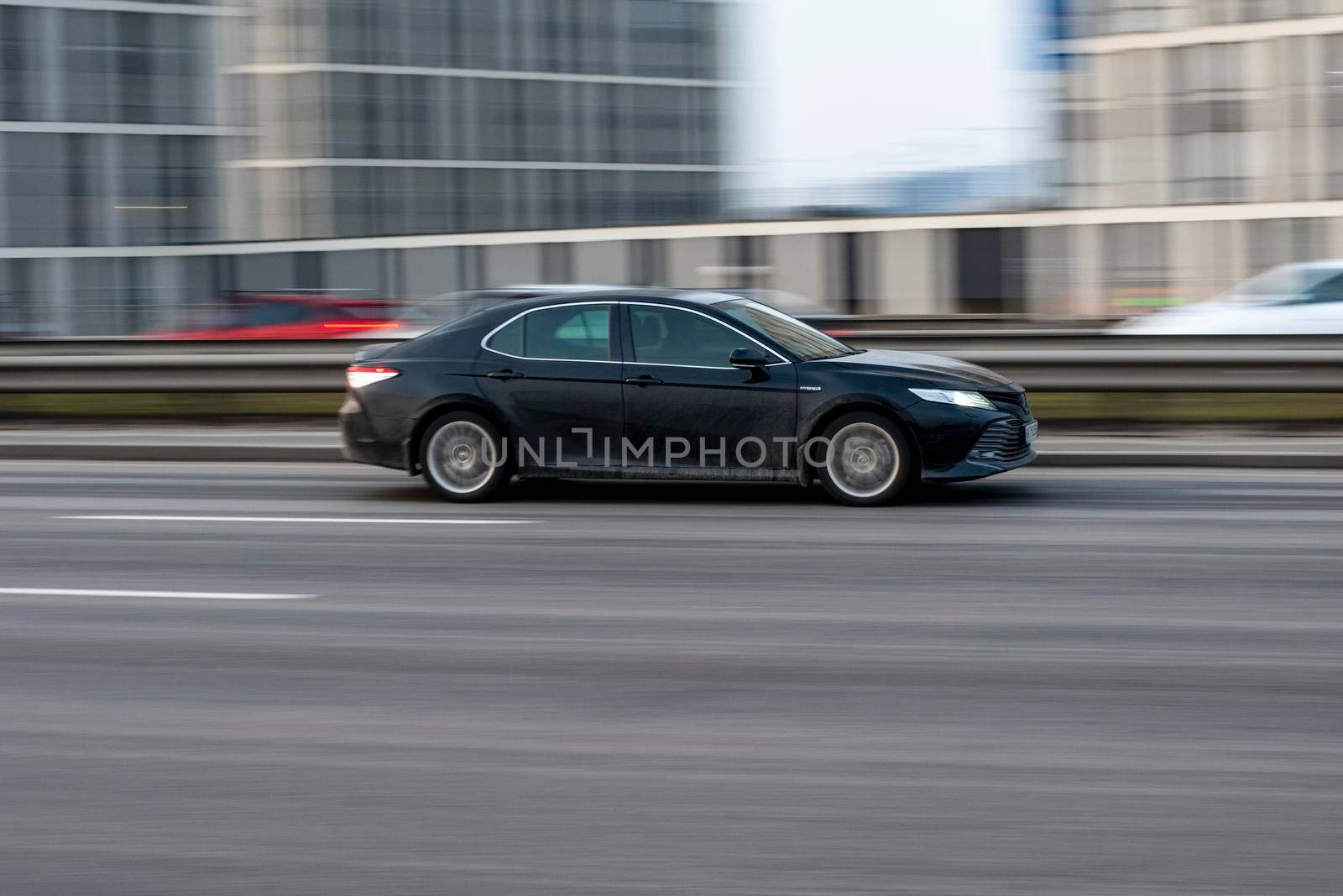 Ukraine, Kyiv - 11 March 2021: Black Toyota Camry car moving on the street. Editorial