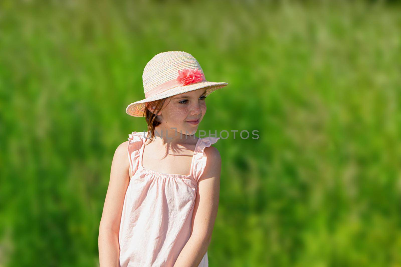 Little cute girl in the hat close-up portrait outdoors. The concept of a happy childhood. High quality photo