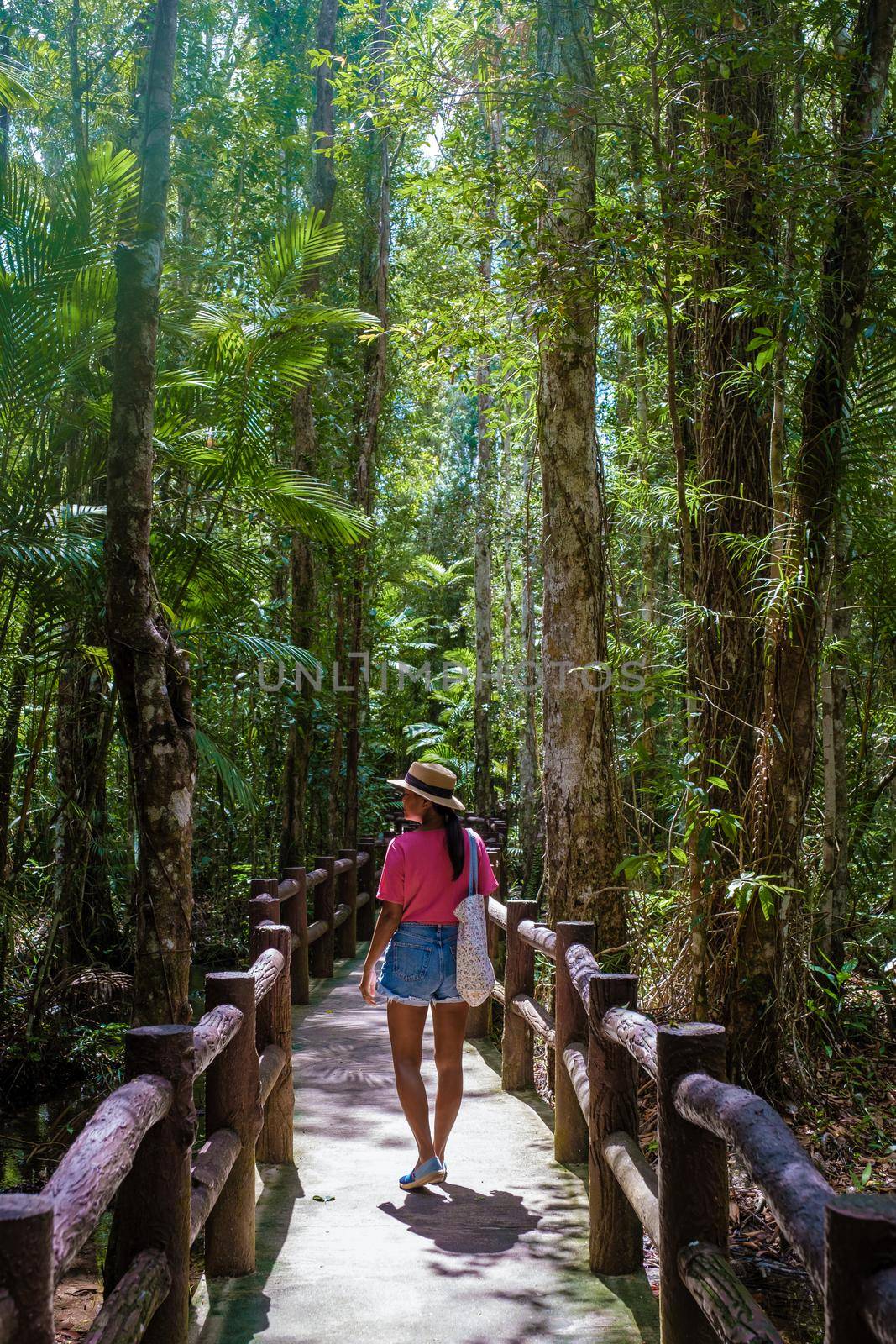 Emerald lake and Blue pool Krabi Thailand mangrove forest Krabi Thailand. Young Asian woman and European men at the lake by fokkebok