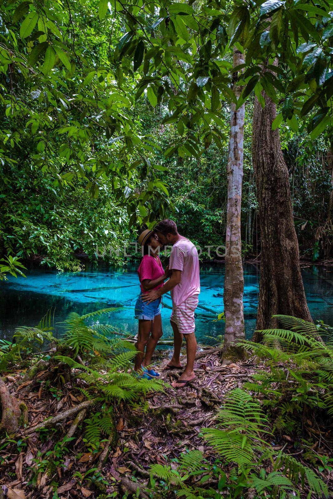 Emerald lake and Blue pool Krabi Thailand mangrove forest Krabi Thailand. Young Asian woman and European men at the lake by fokkebok