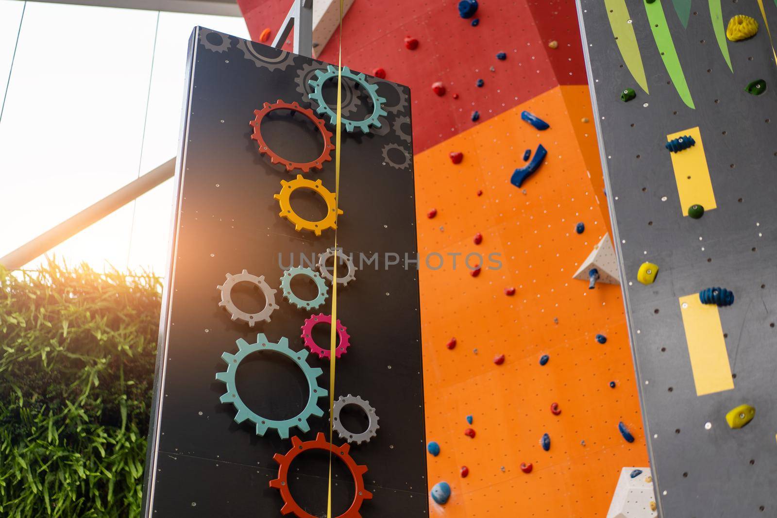 Indoor bouldering and climbing wall for training at modern gym. Gears and toy climbing wall for children extreme sport