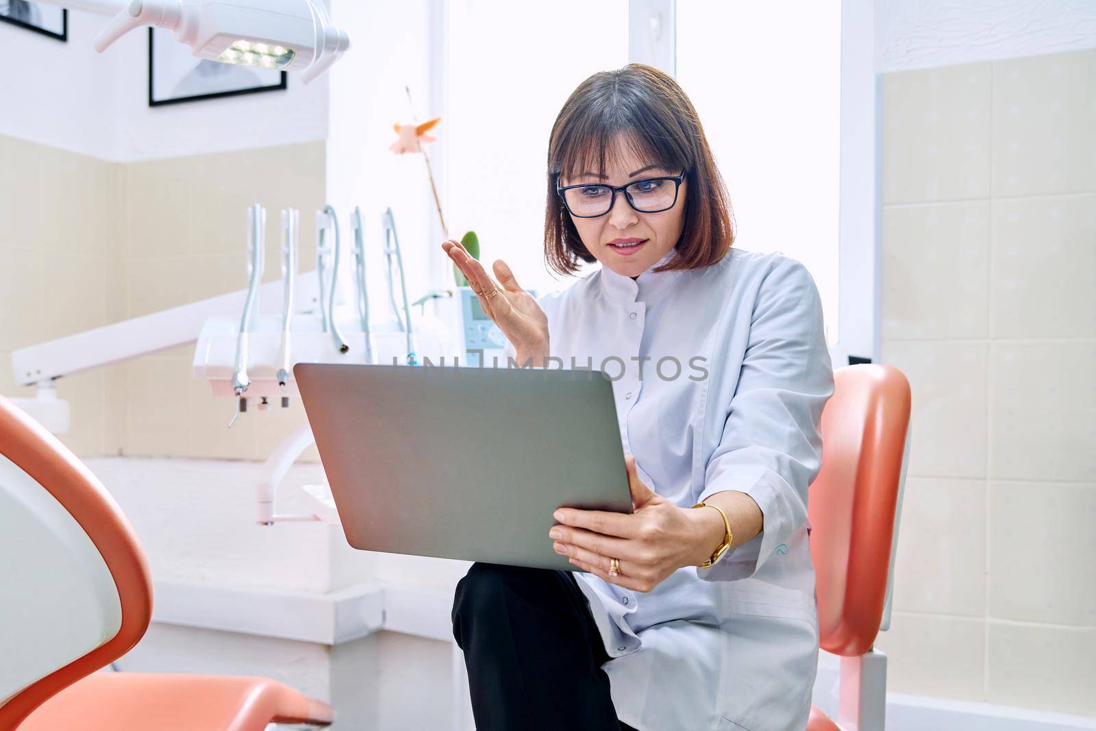 Online consultation, doctor help in clinic using laptop. by VH-studio