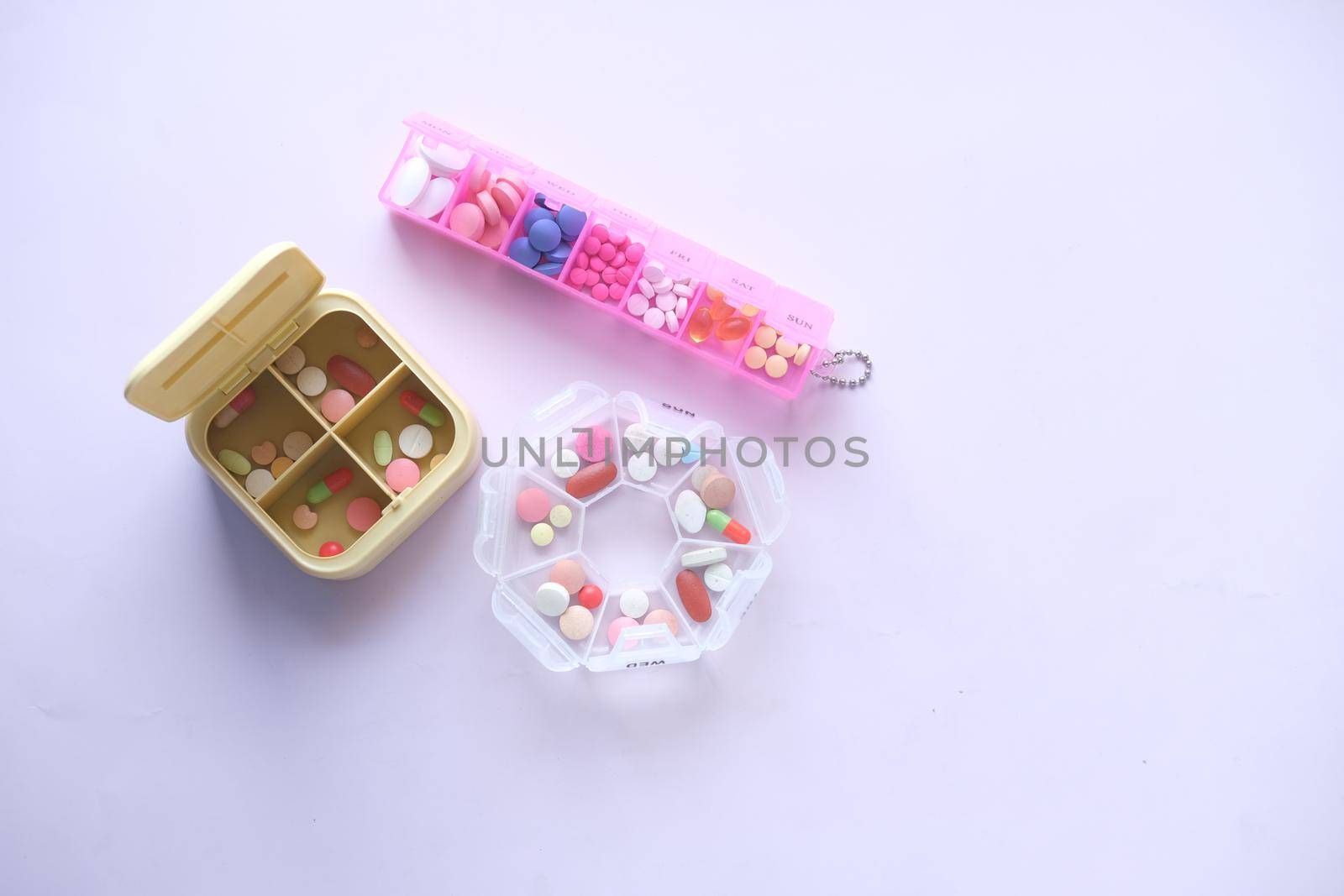 top view of medical pills in a pill box on white background .