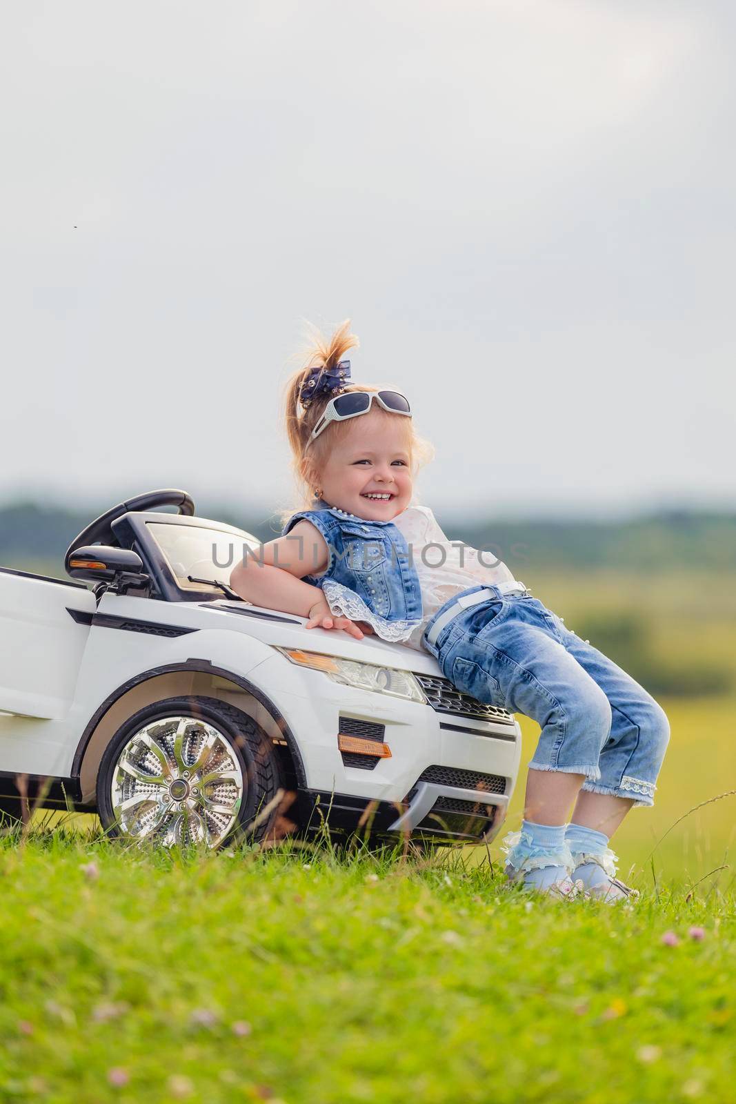 girl standing near her baby car by zokov