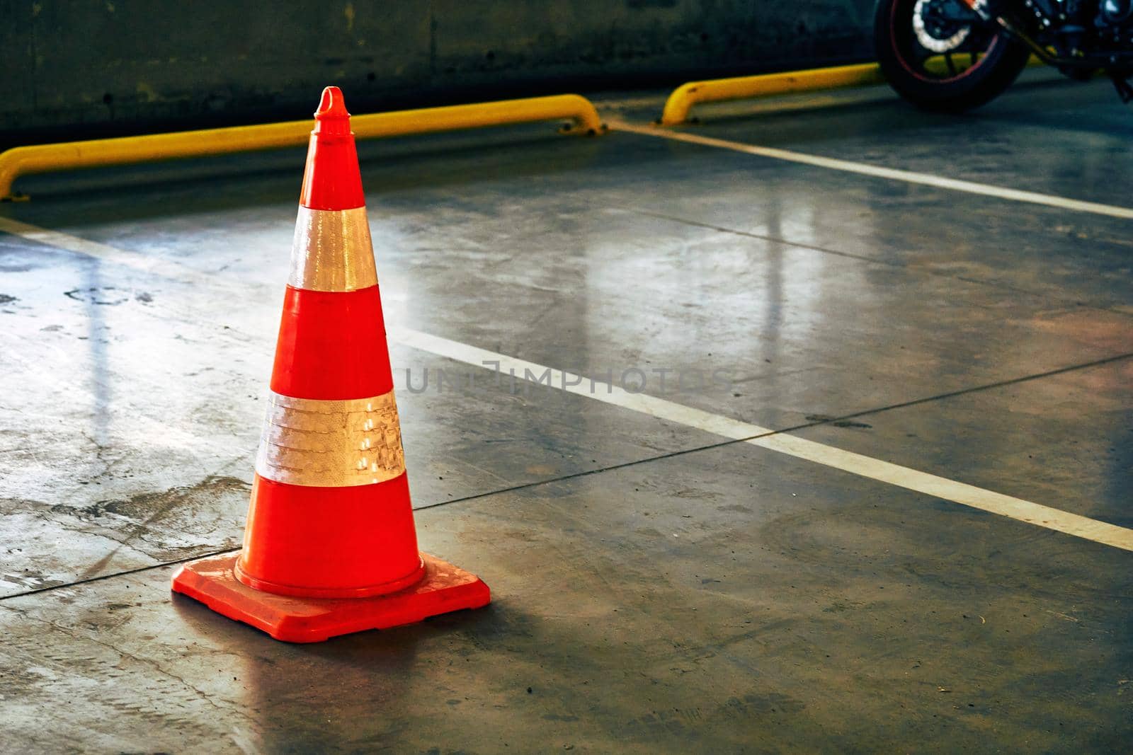 Reflective traffic safety cone in a closed parking lot by jovani68