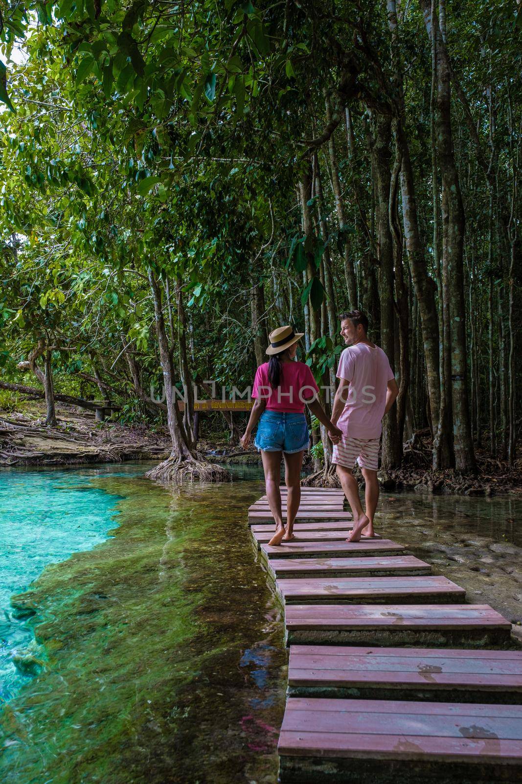 Emerald lake and Blue pool Krabi Thailand mangrove forest Krabi Thailand. Young Asian woman and European men at the lake by fokkebok