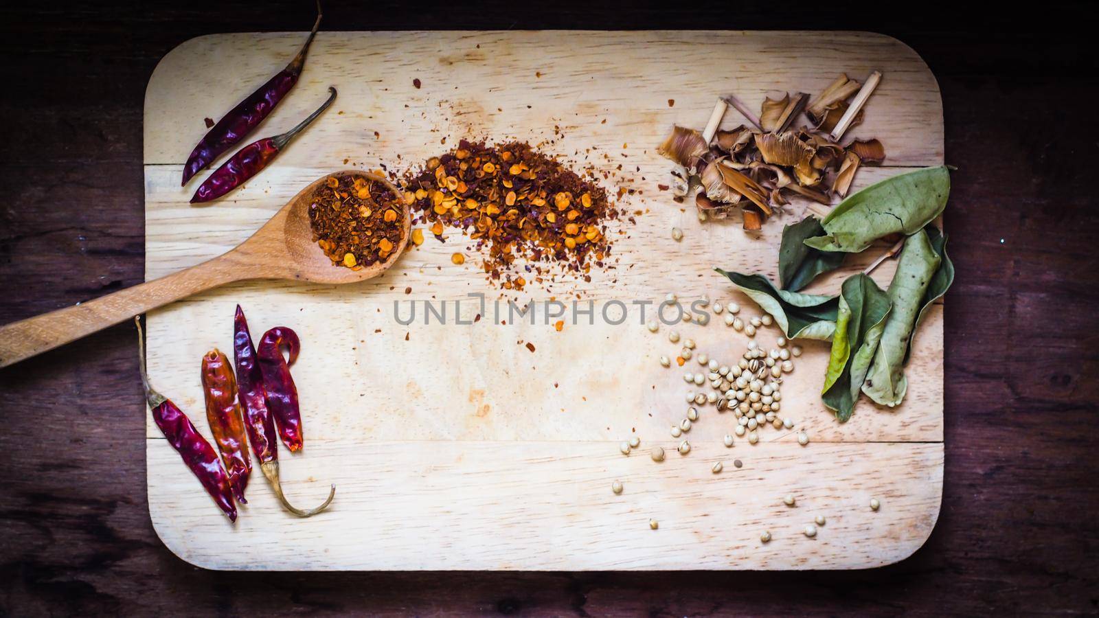 Wooden spoon with different types of quinoa Thai food ingredient and space for text on wooden table background, top view
