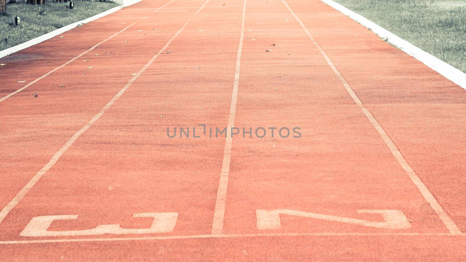 Starting line on running track .Red running track Synthetic rubber on the athletic stadium by Petrichor