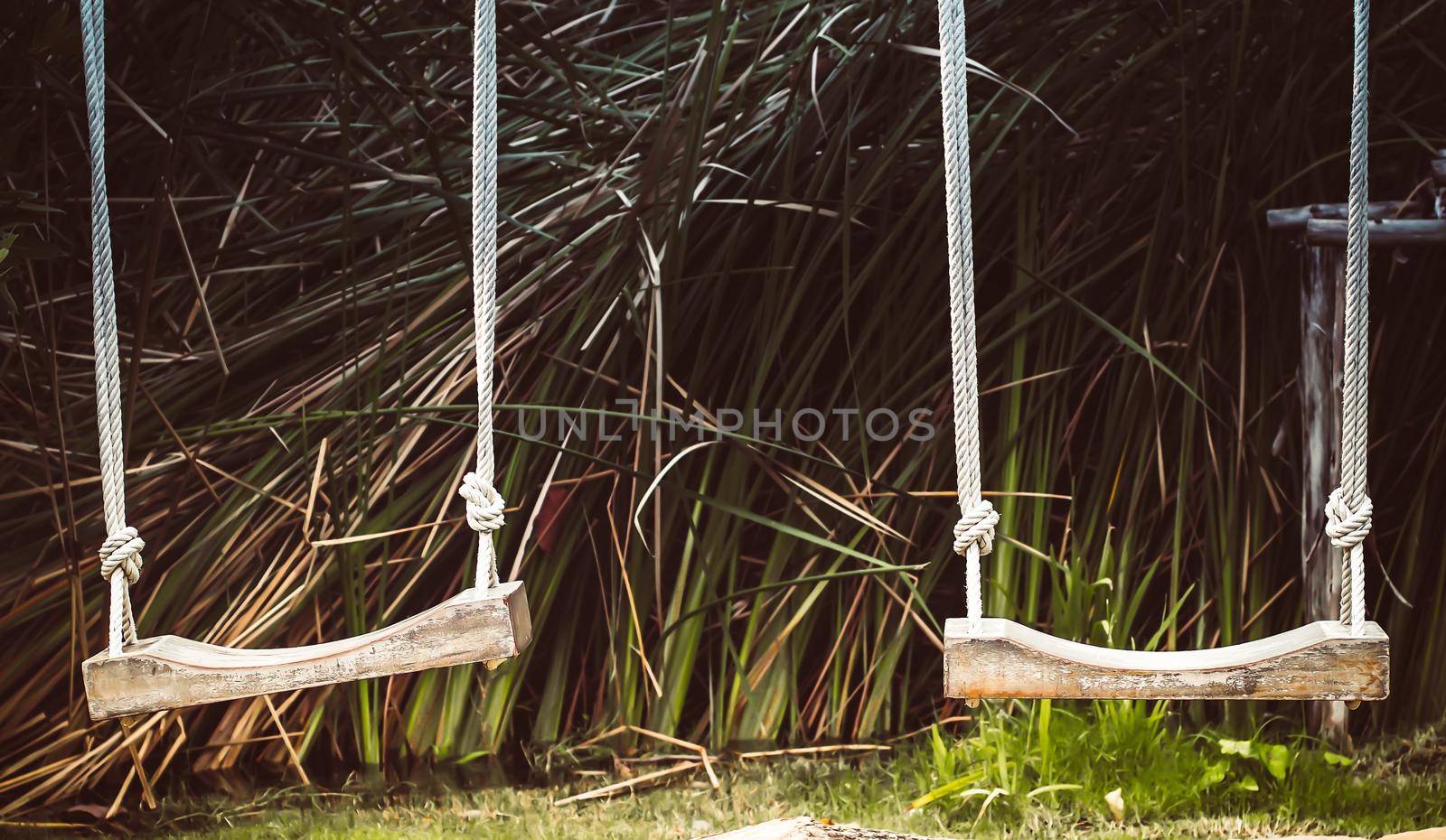 Empty swing on children playground, Children swing in the park, wooden swing, wooden