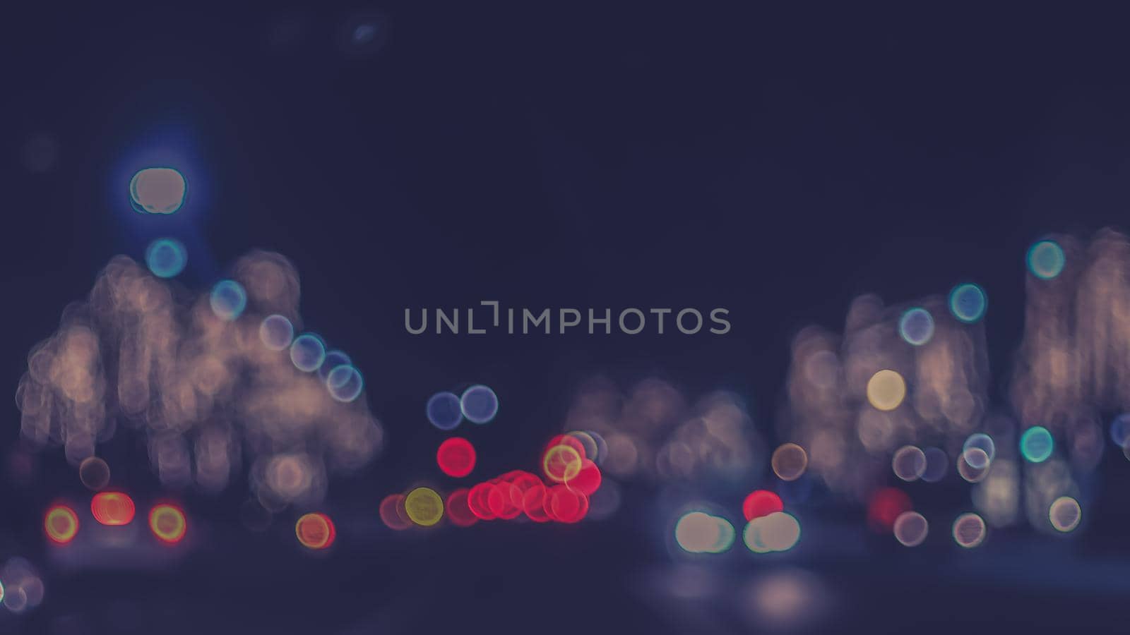 Defocused night Street lights. Bokeh street lights from cars in the city.