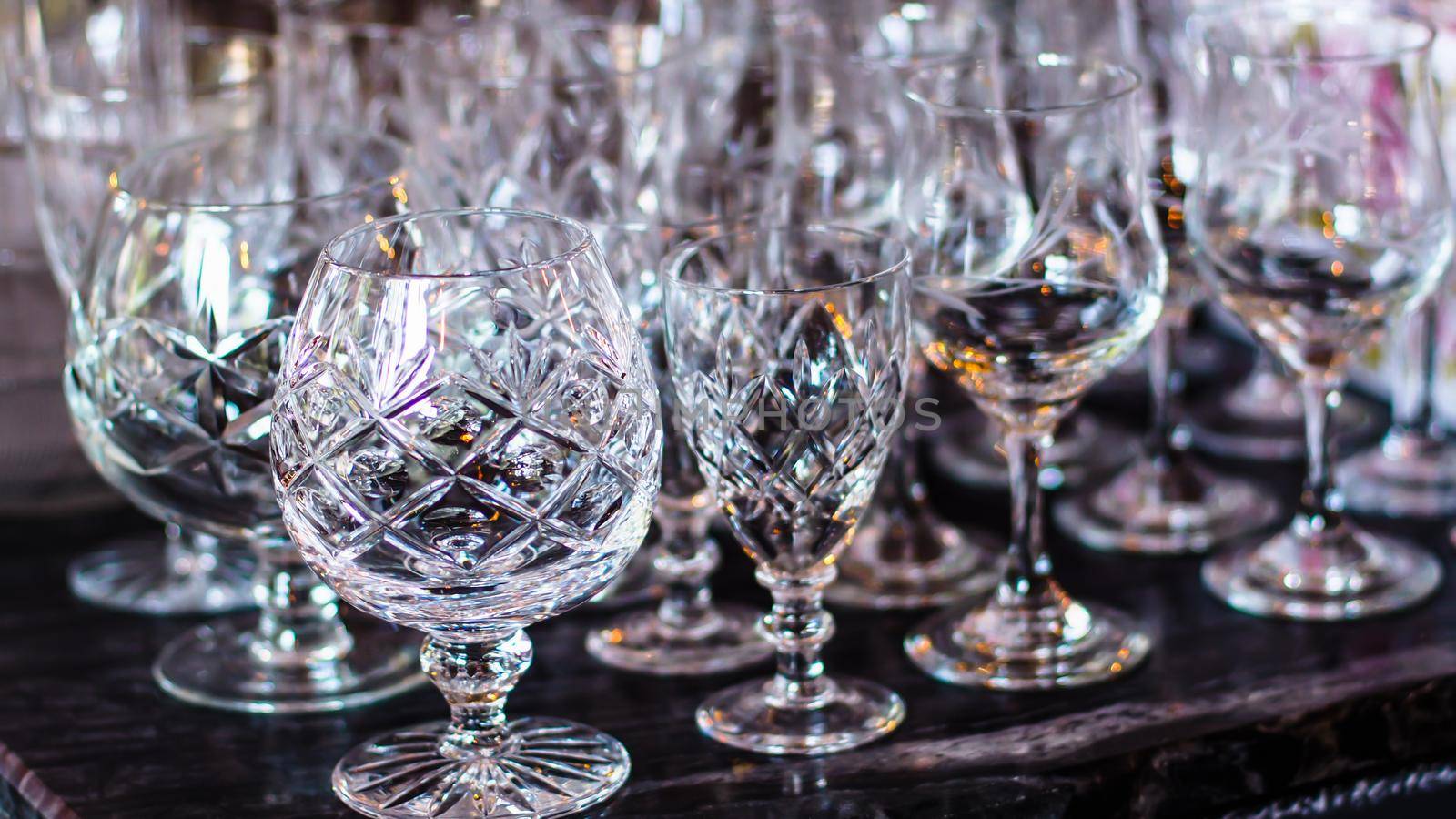 Close up picture of empty crystal wine glasses in restaurant
