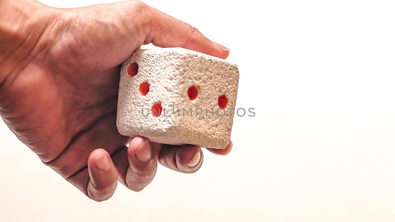 Hand & Rolling Dice. Hand rolls a dices on white isolated background. Selective focus. Dice is blur due to movement. Roll the dice concept