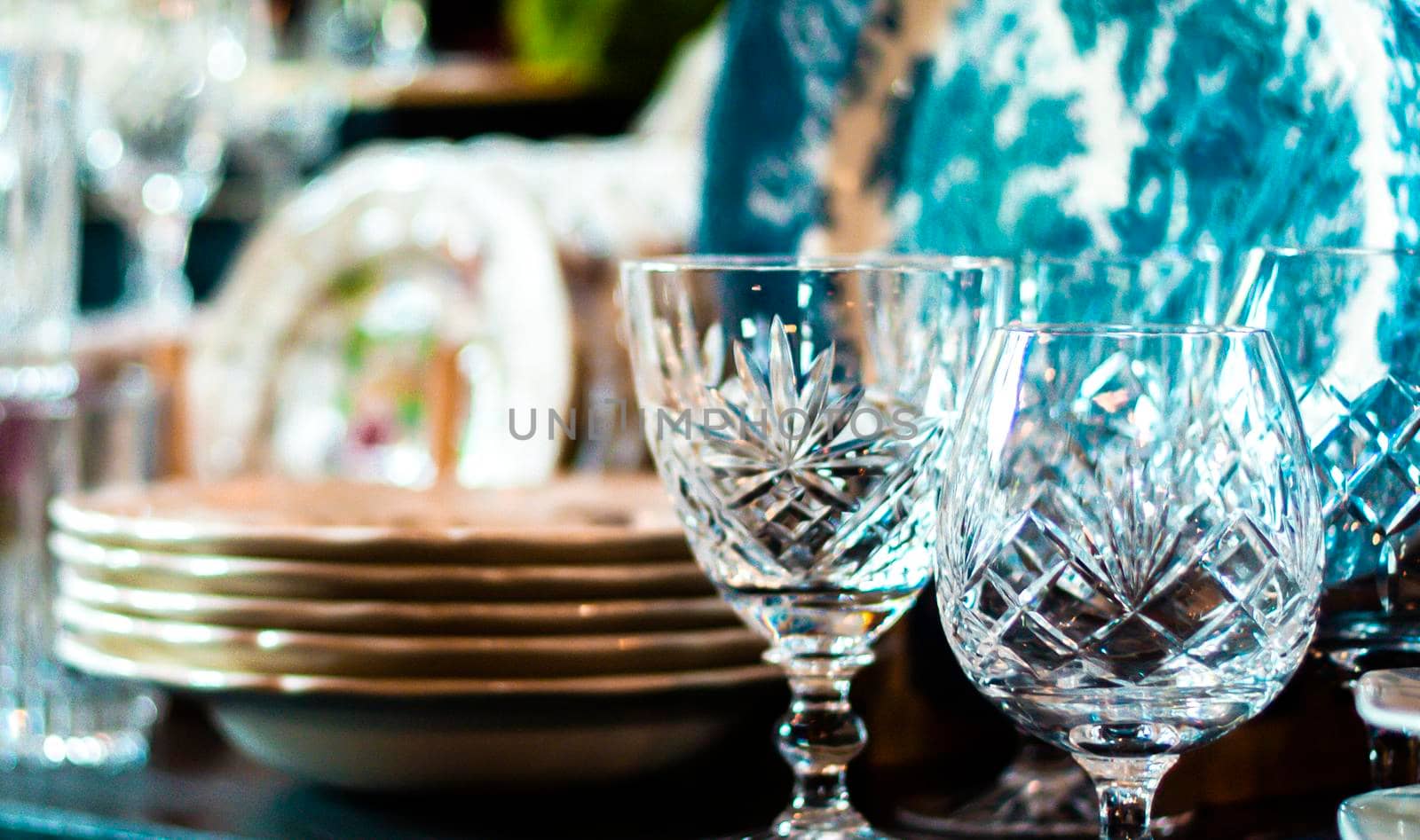 Set of Vintage crystal glasses on the black tray with Christmas decorations. Selective focus