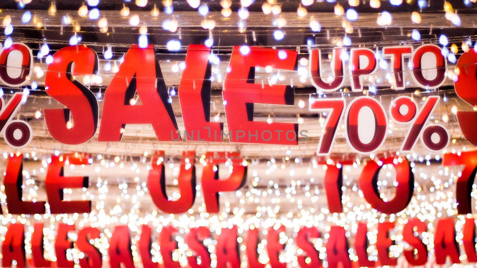 Store sale sign. Special offer banner with the red sale text gold bokeh blur background