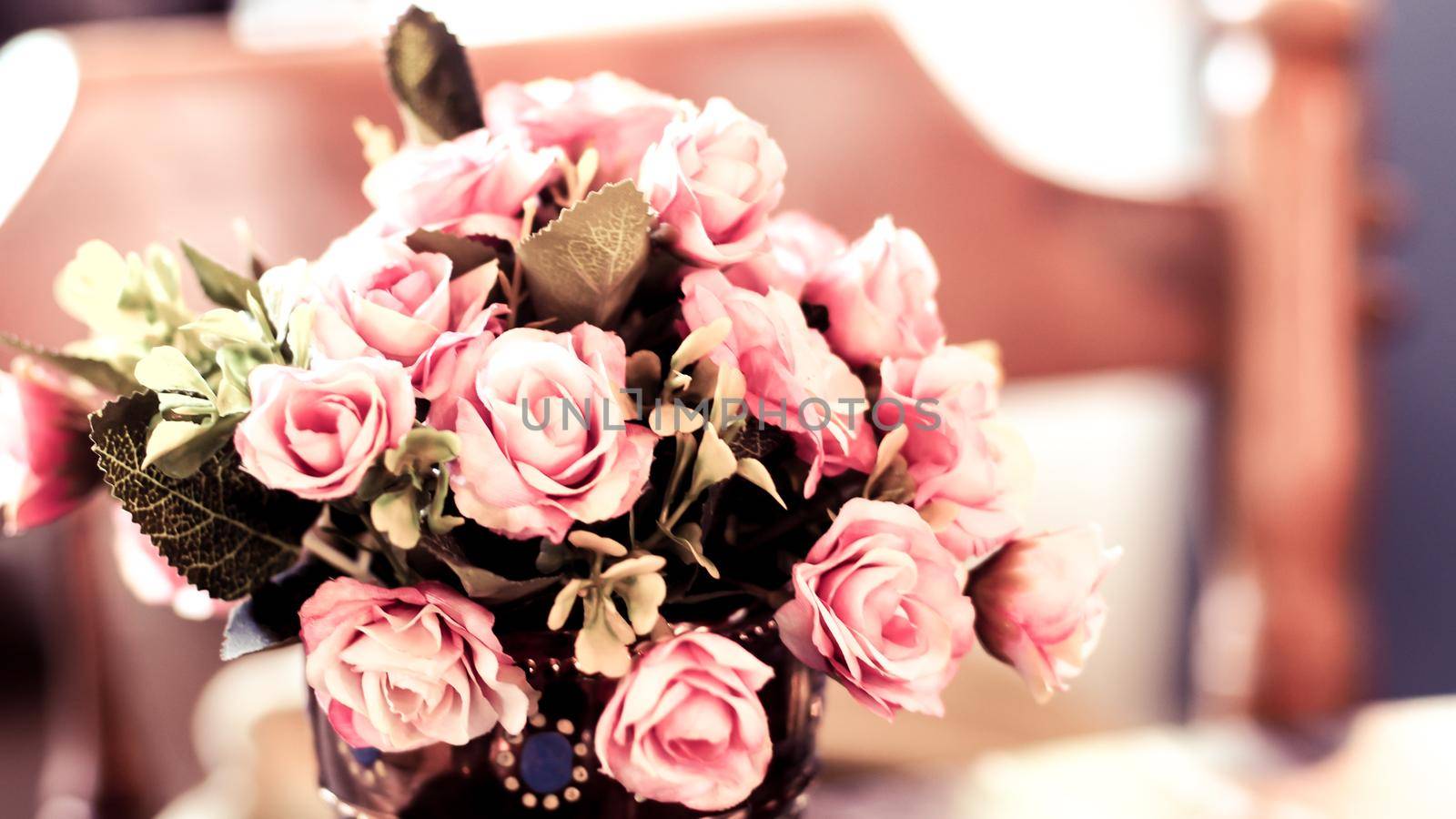 Bouquet vintage group of pink roses on wooden table, soft focus by Petrichor