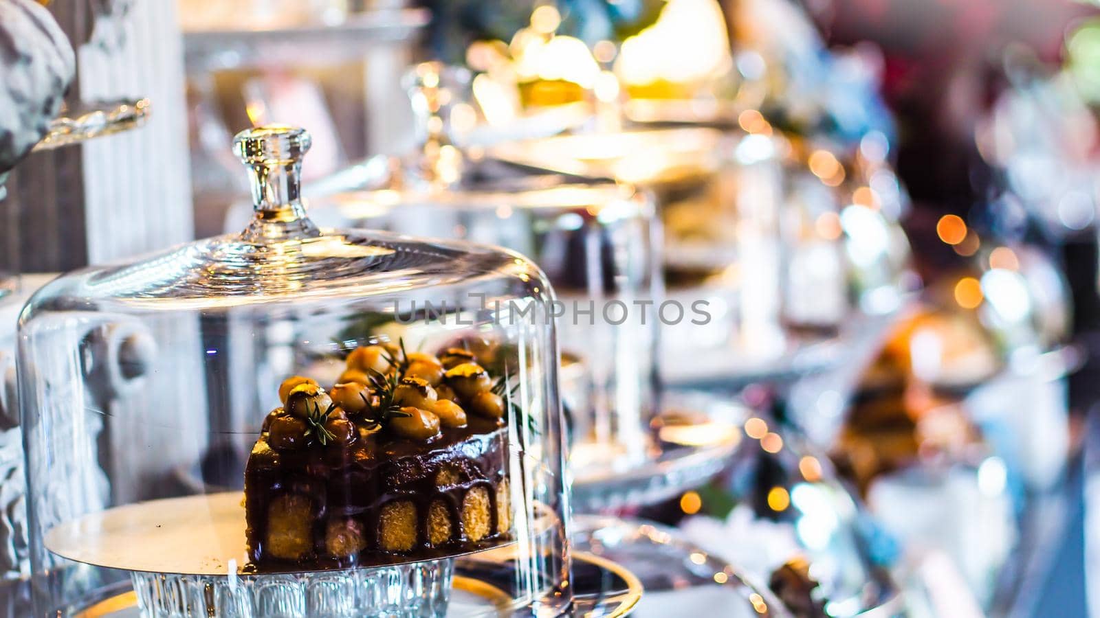 Delicious cake with peanut butter cream layer and chocolate topping. Bakery shop background. Selective focus