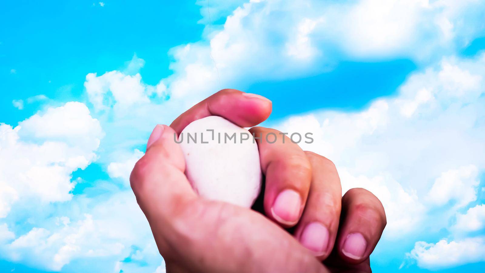 stone held in hands . Hand hold stone ball in nature. Circular stone