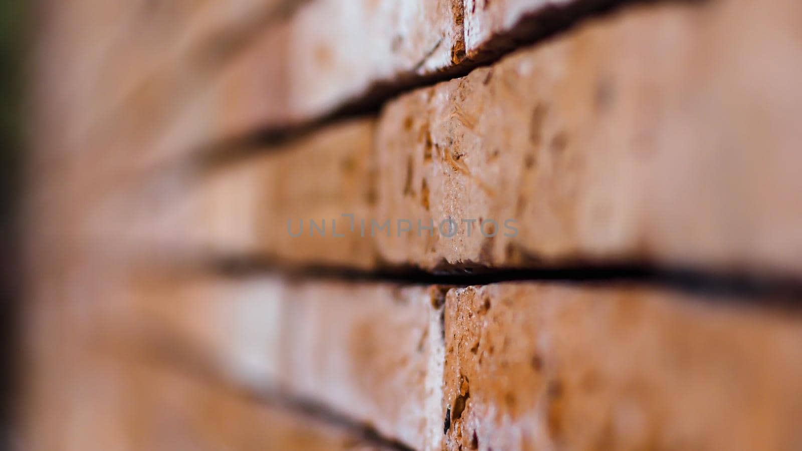 Close up of red brick wall ending in infinity with shallow DOF. Texture of old concept background by Petrichor