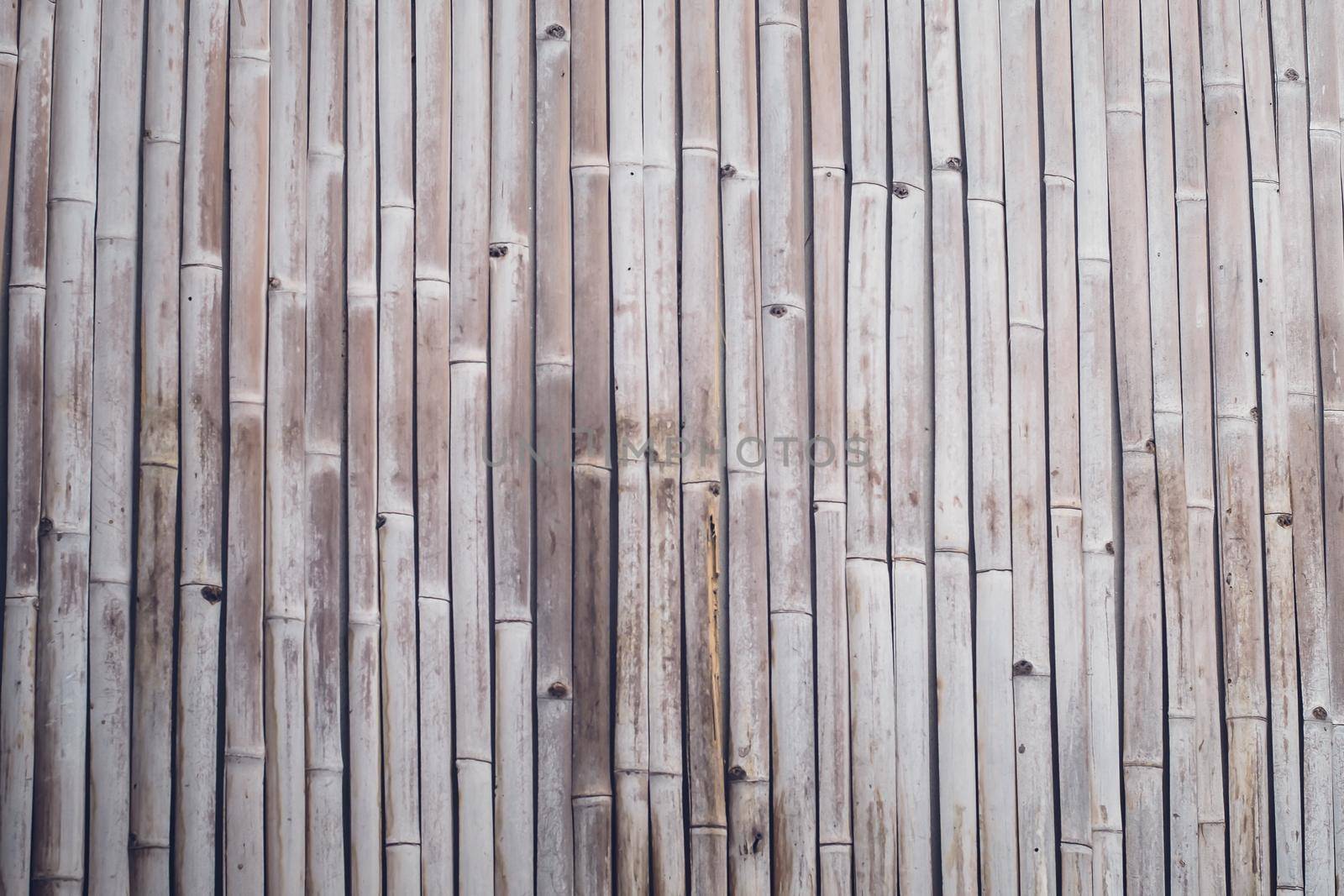 Old brown tone bamboo plank fence texture for background. Close up decorative old bamboo wood of fence wall background by Petrichor