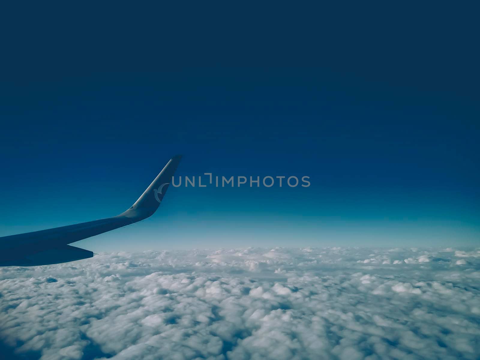 airplane wing .Top aerial view of island mountain clouds from airplane