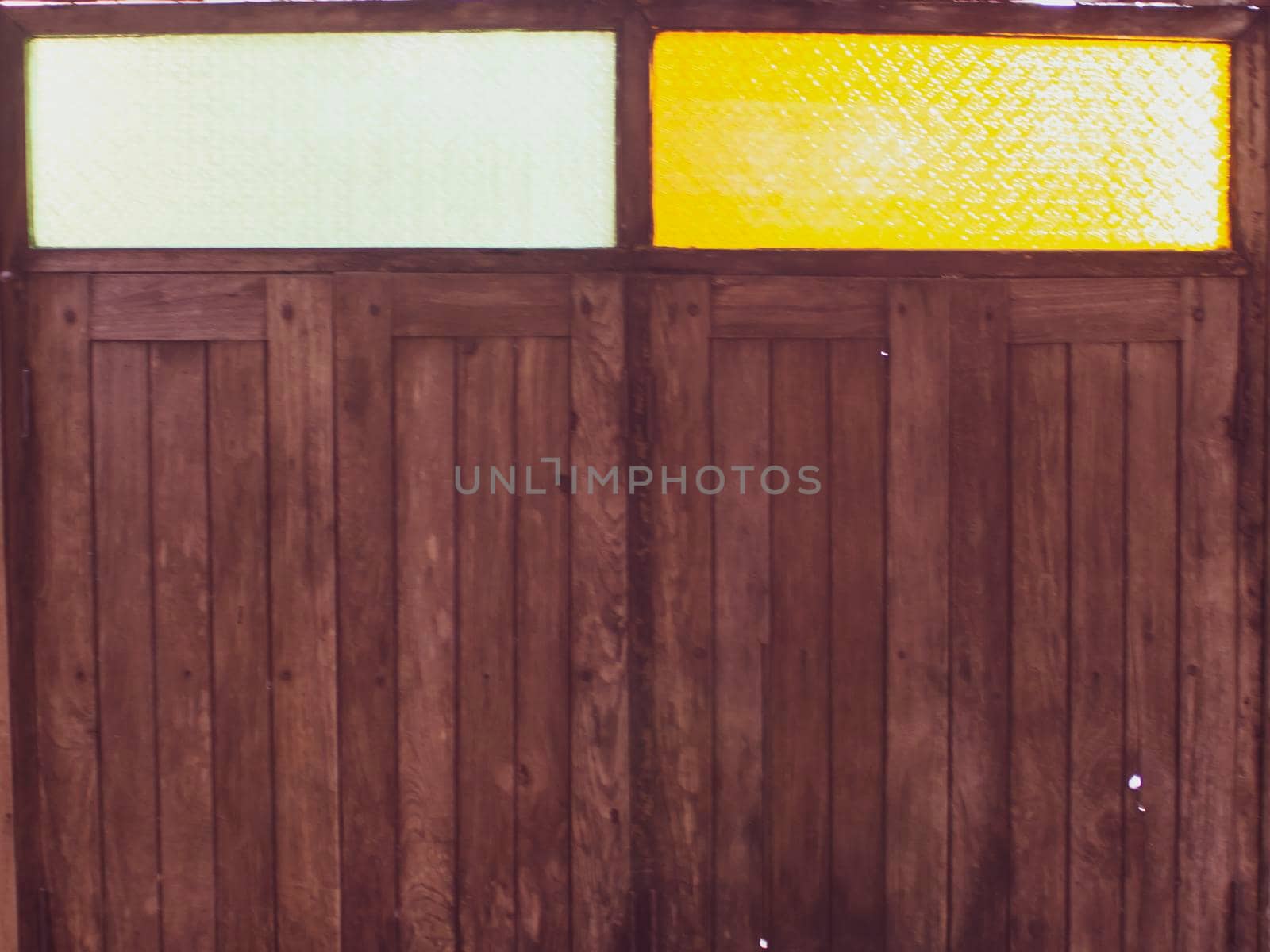 Colorful glass over old wooden window for sunlight detail for vintage architecture by Petrichor