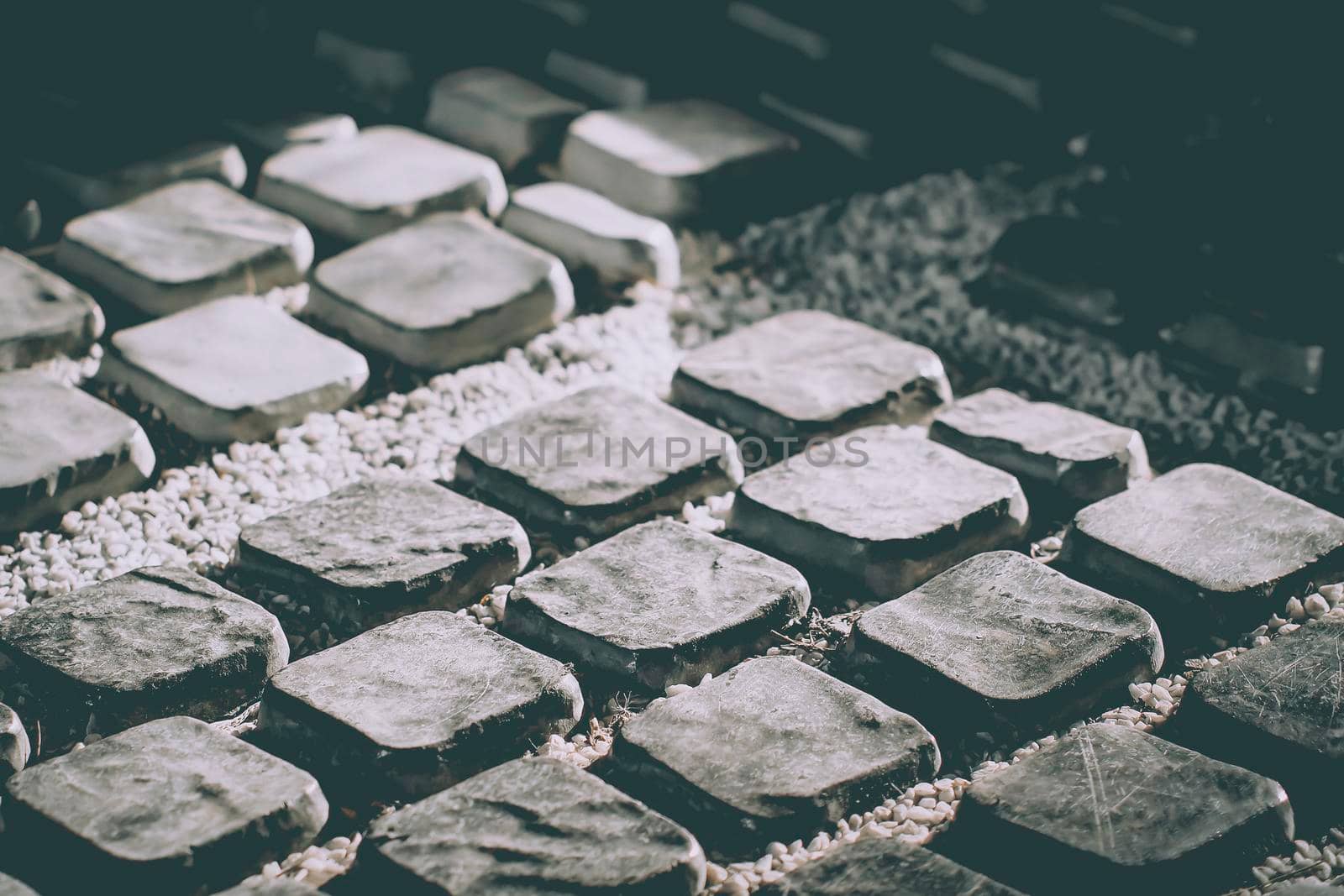 Piece of stone is material for Pavement in a street footpath walkway landscape decoration by Petrichor