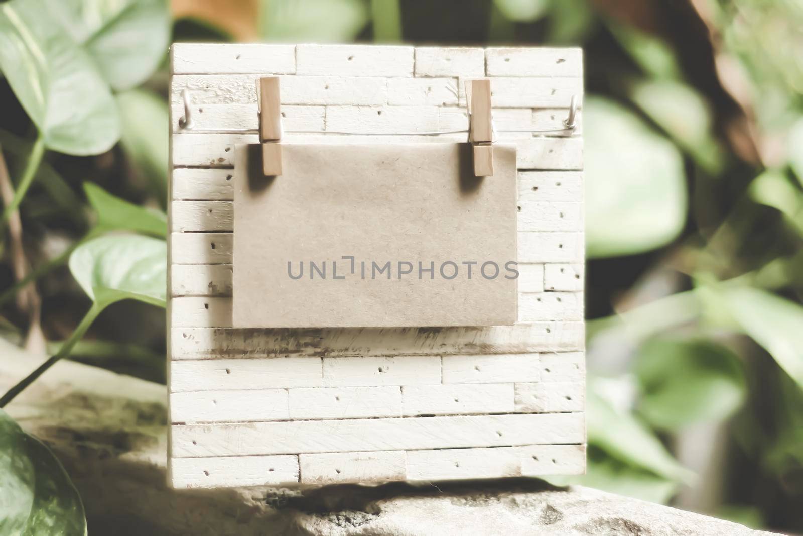 Wooden old billboard with blank sheet for notes. Nature blur background by Petrichor