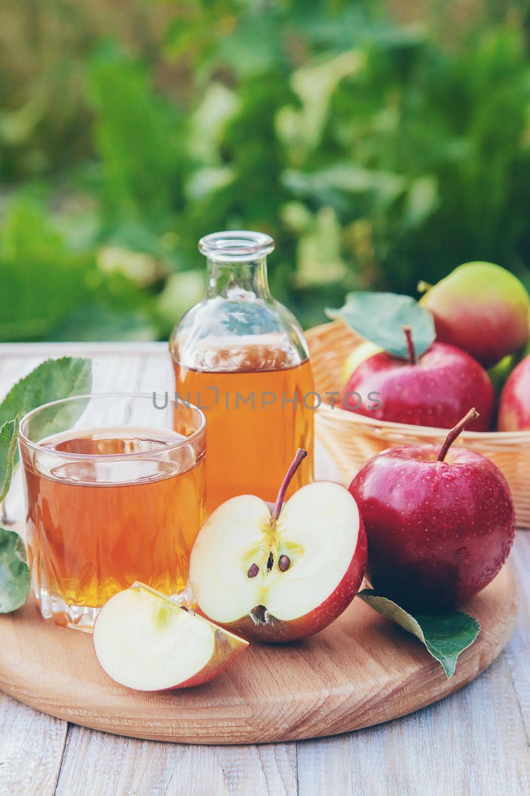 Apple juice in a glass. Selective focus. by yanadjana