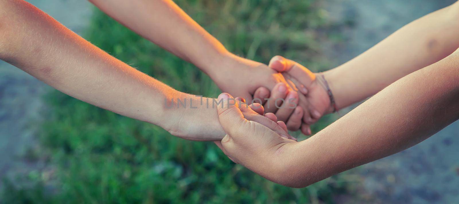 children hold hands together. People. Selective focus. by yanadjana