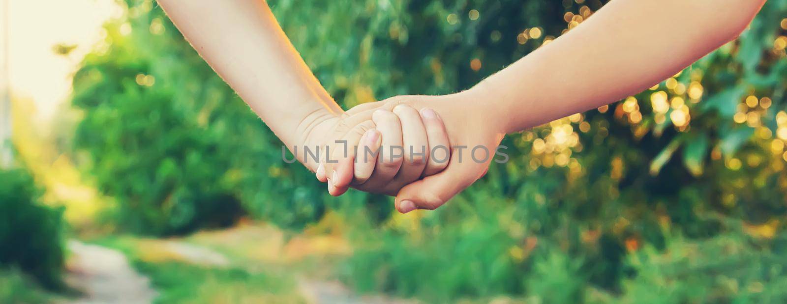 children hold hands together. Selective focus. nature.