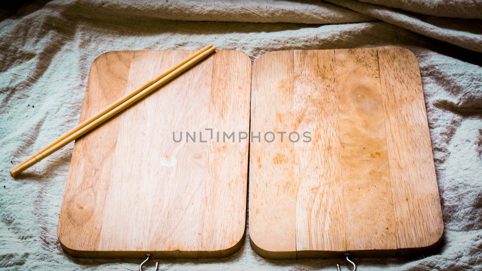 Wooden plate blank with chopsticks, on natural linen cover table on white table, top view .cooking food menu idea background