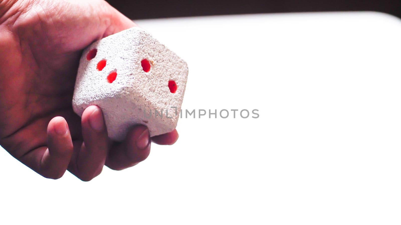 Hand & Rolling Dice. Hand rolls a dices on white isolated background. Selective focus. Dice is blur due to movement. Roll the dice concept by Petrichor