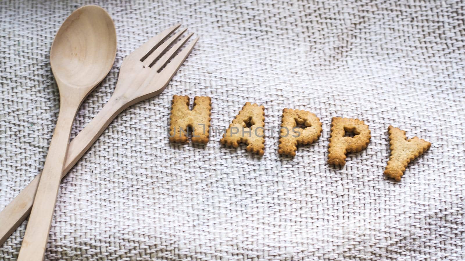 Cookies in the form of the alphabet prospect. Happy from homemade cookies on dark white background. Happy cookies concept