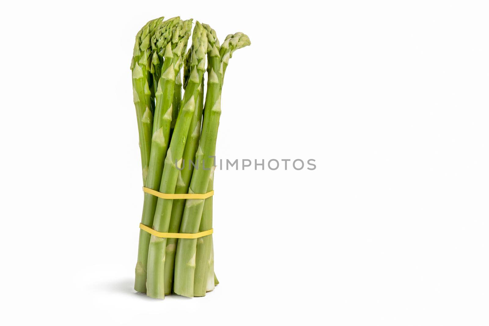 Bunch of fresh green asparagus isolated on white background. Freshly picked asparagus with water drops isolated on white background