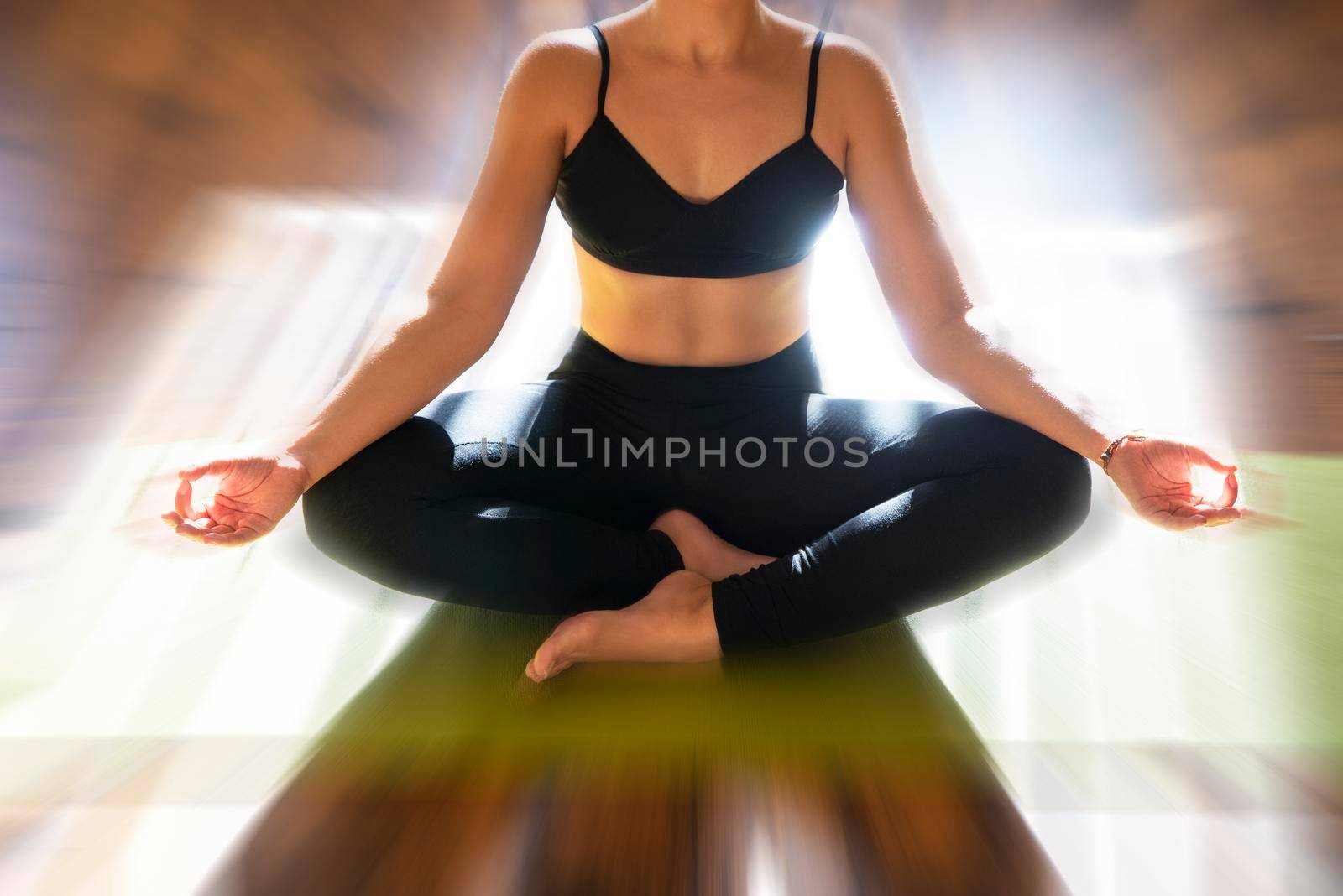 Young woman meditating sitting in lotus position