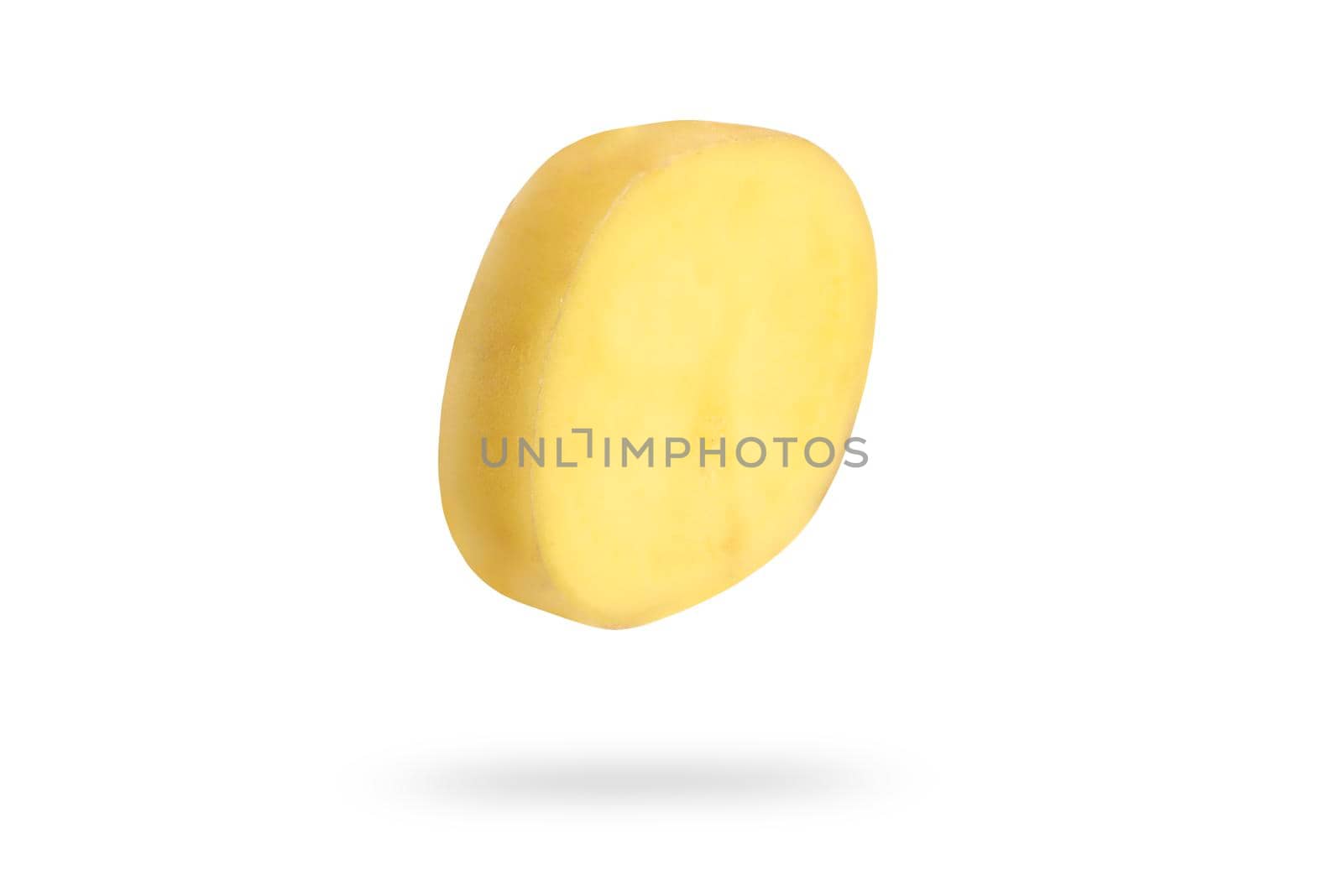 A slice of fresh unpeeled potatoes falls on a white background. Chopped raw potatoes. Food levitation concept. High resolution image.