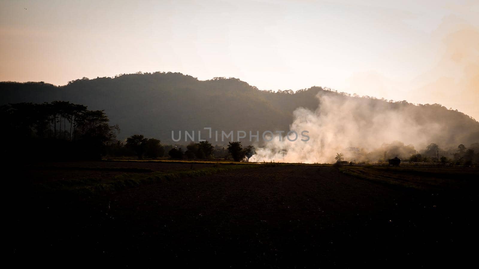 moke rising from the ground summer field mountain background PM2.5 nature idea