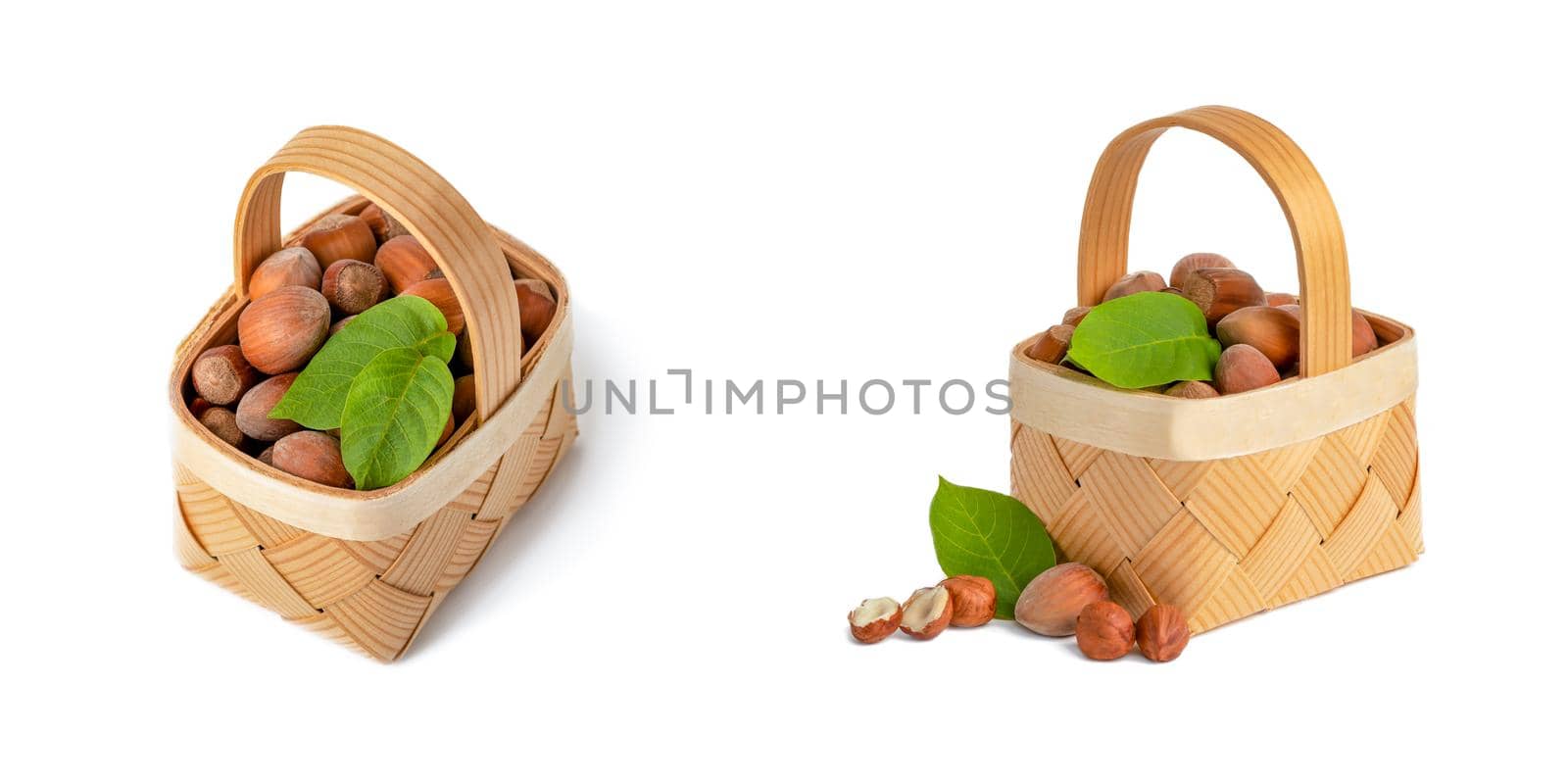 Hazelnut lies in a wooden basket on a white isolated background. Unpeeled hazelnuts in shell and green leaves.