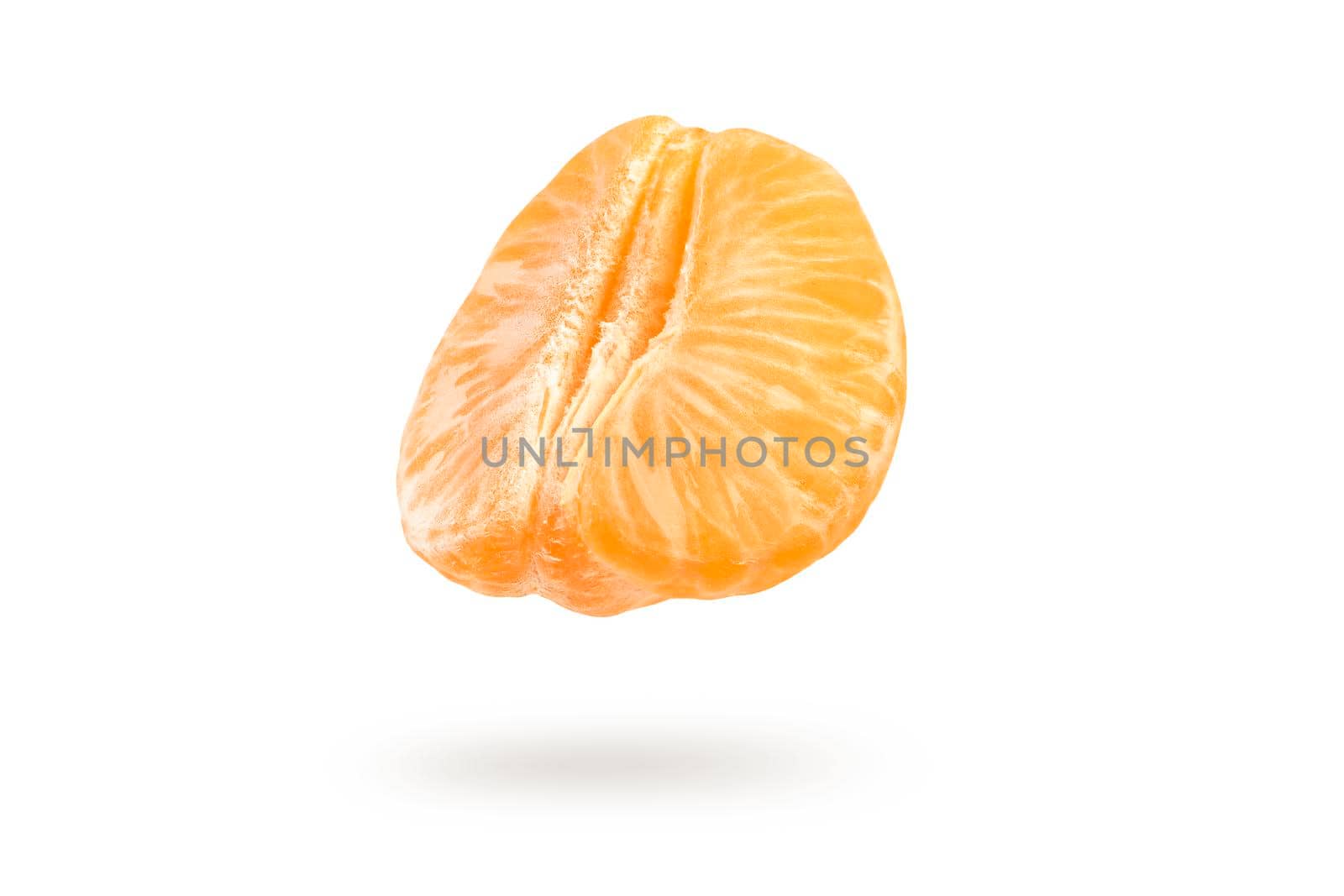 A piece of mandarin isolated on a white background, falling casting a shadow. Individual segments of tangerine slices, for inserting into a project or design