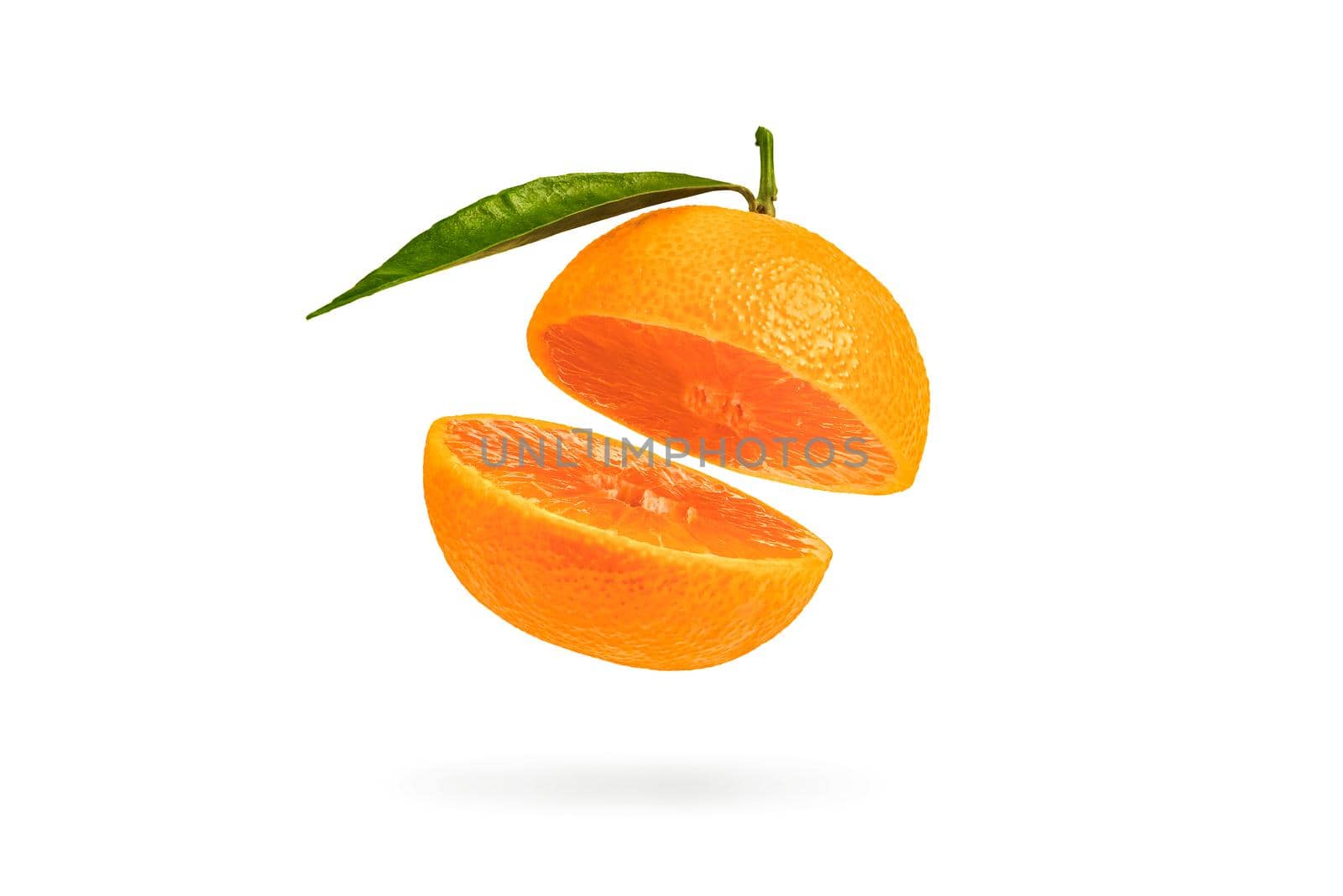 Mandarin cut in half with a green leaf. Fresh tangerine on a white isolated background. Open mouth concept. Tangerine texture close up